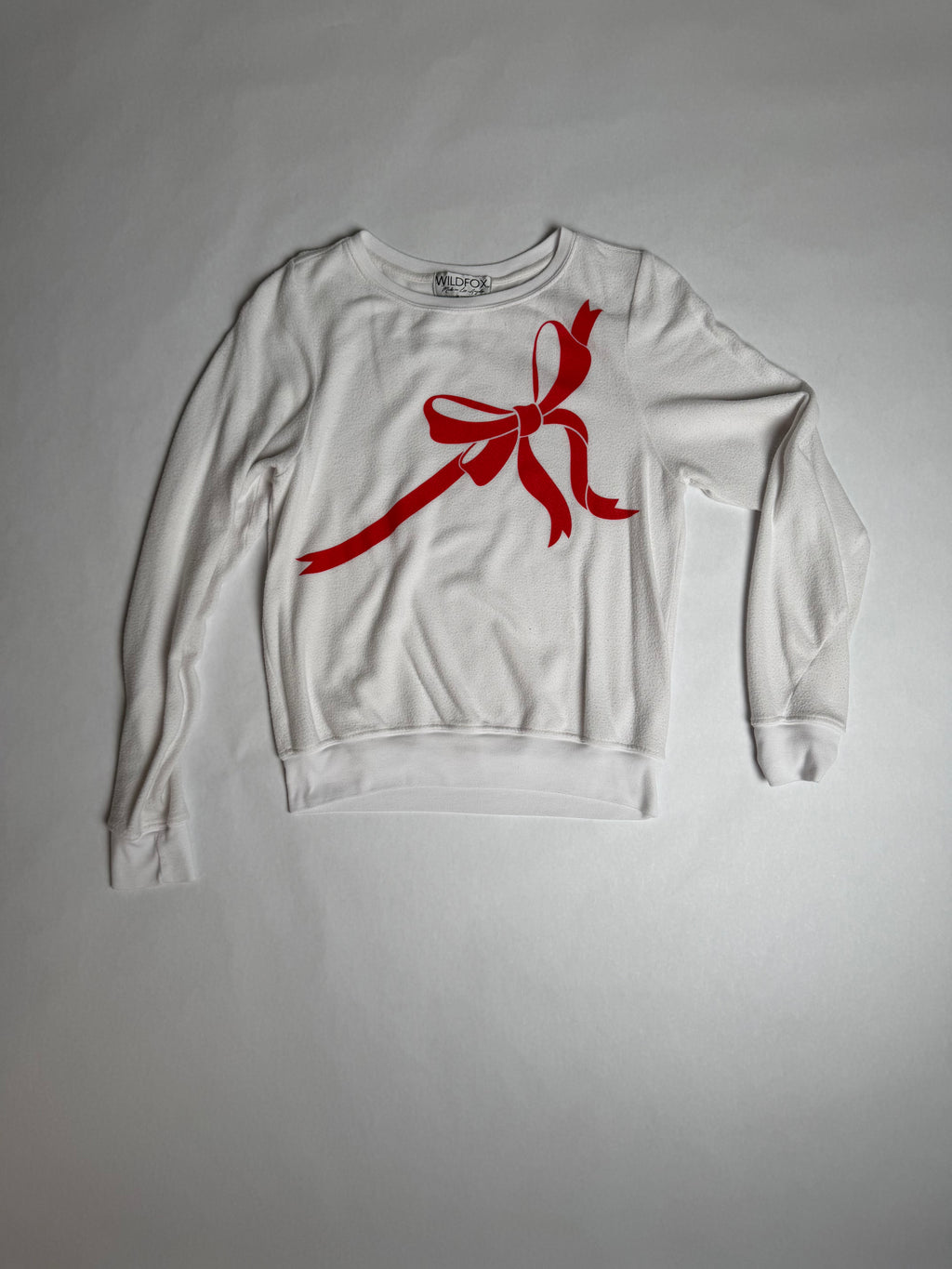 Wildfox cream baggy beach jumper with red ribbon bow — front